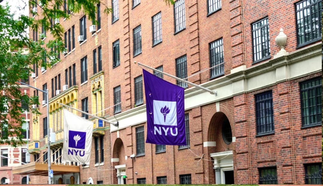 NYU purple flags on a brick building in Greenwich Village