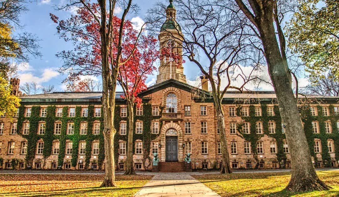 Nassau Hall at Princeton University framed by fall trees