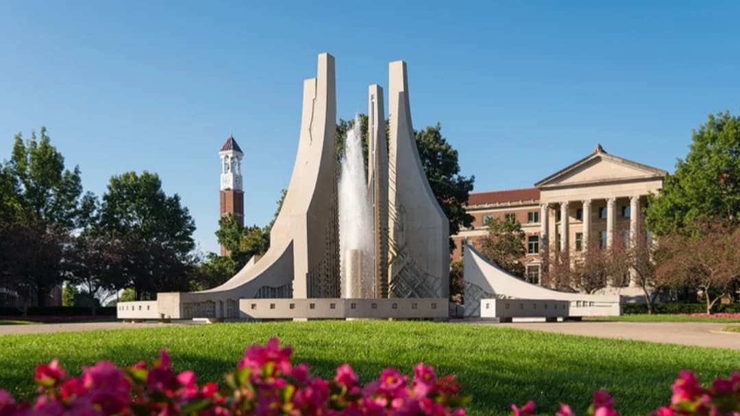 Purdue's Engineering Fountain with the bell tower and pink flowers in front